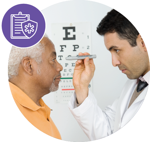 Doctor shining light into elderly man's eye